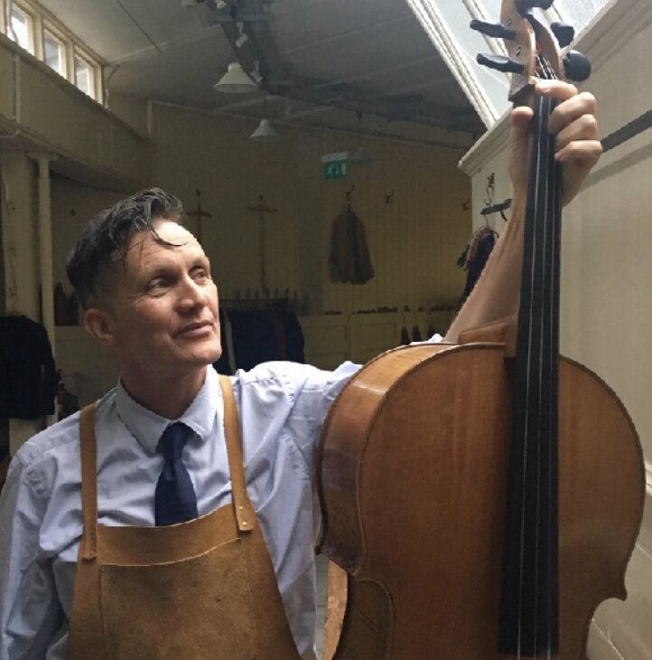 Robert Brewer Young with cello in his workshop